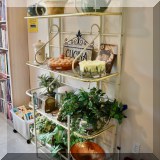 F28. Metal baker's rack with glass shelves and brass accents. 68”h x 38.5”w x 15”d